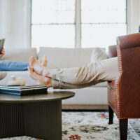 detail shot of a custom lounge chair with man sitting in it with his feet up