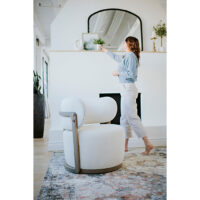 a white accent chair in a white living room