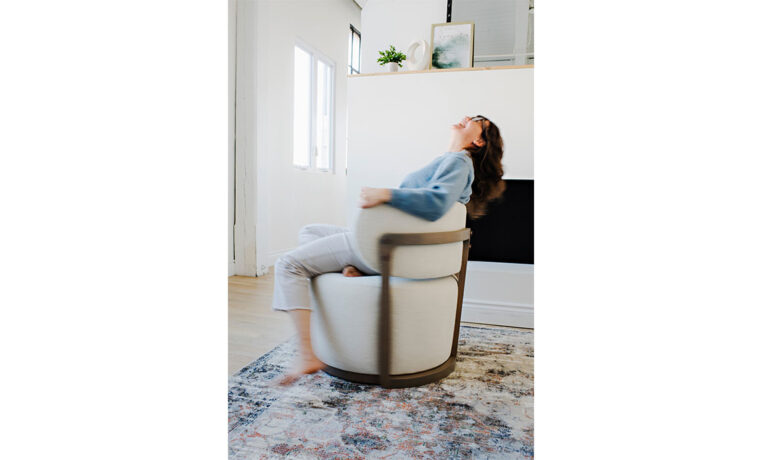 a woman twirling in a custom white swivel chair